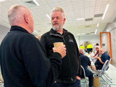 2 men chatting over coffee at the AMSA event